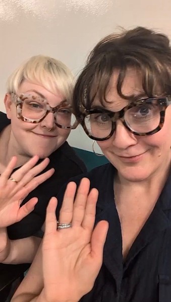 Blagica Bottigliero with a friend at a women-in-AI meetup, both laughing in a selfie, hands raised — the kind of room where vibe coders are quietly shipping.